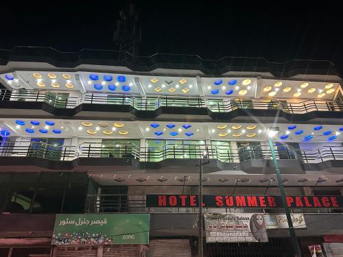 a building with balconies and a hotel at night at Hotel Summer Palace Murree in Murree