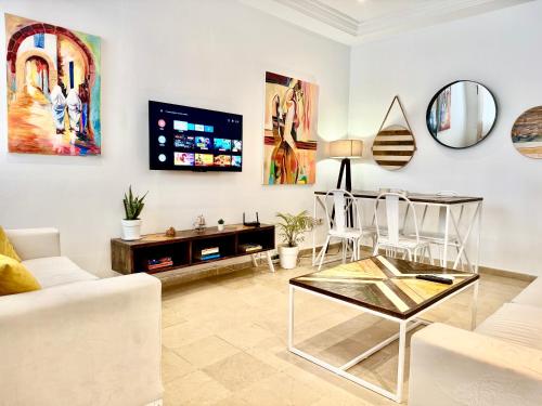 a living room with a couch and a table at Cosy Triplex in La Marsa in La Marsa