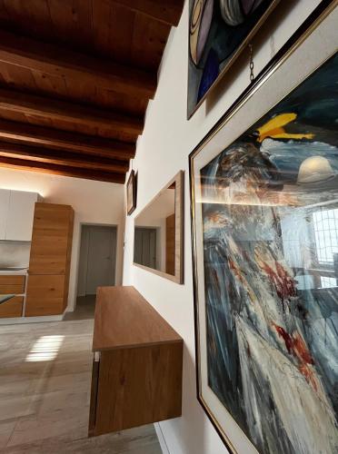 a room with paintings on the wall and a table at The Italian home you deserve in San Pietro in Cariano