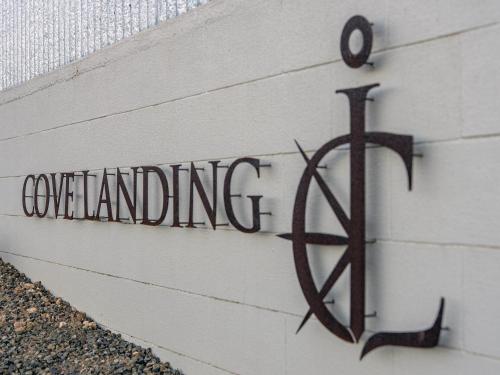 a sign on the side of a building with a dollar sign at Cove Landing Marina Apartment 2 SS James Comrie Sleeps 4 in Penneshaw