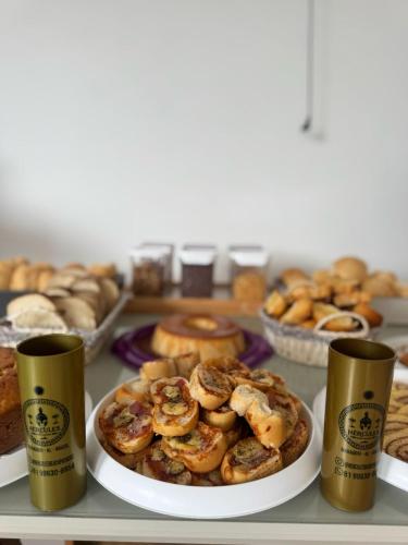 a plate of pastries on a table with other baked goods at Pousada Hércules Beach Paradise in Maragogi