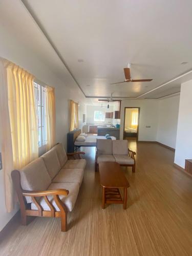 a living room with a couch and a table at Kanasu Serenity in Gokarna