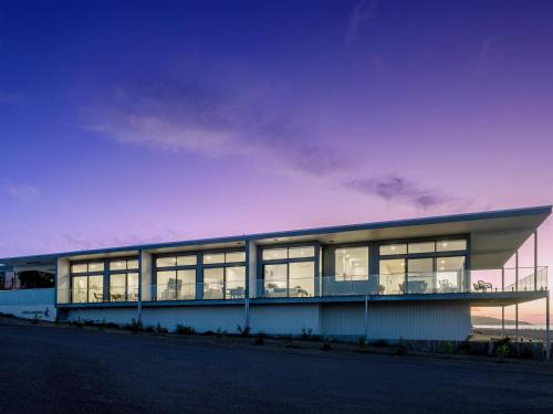a building with large windows on the side of it at Cove Landing Marina Apartments CL01-Apt:1,2,3 Sleeps 12 in Penneshaw