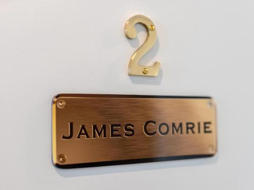a sign that reads james compare hanging on a wall at Cove Landing Marina Apartments CL01-Apt:1,2,3 Sleeps 12 in Penneshaw