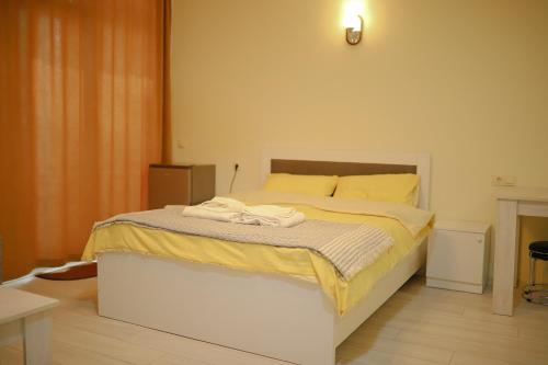 a bedroom with a bed with towels on it at LS Apartment Near The Beach in Kakhaberi