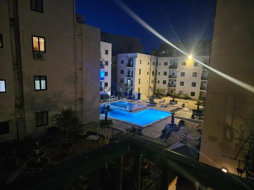 a view of a swimming pool at night with buildings at Apartment with pool in St. Paul's Bay