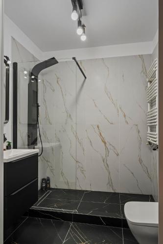 a bathroom with a shower and a sink and a toilet at Bucharest Central Apartment in Bucharest