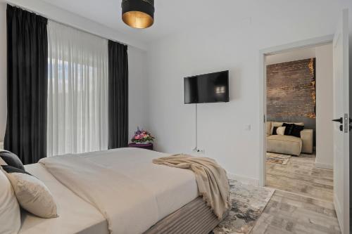 Ένα ή περισσότερα κρεβάτια σε δωμάτιο στο Bucharest Central Apartment