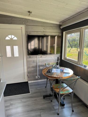 a dining room with a table in a tiny house at Carpe Diem in Zandvoort