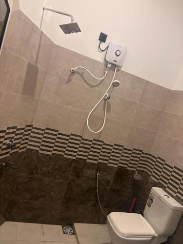 a bathroom with a toilet and a shower at Isuru Villa Weligama in Weligama
