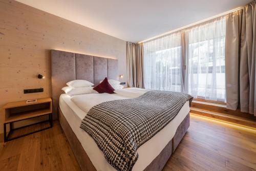 Ένα ή περισσότερα κρεβάτια σε δωμάτιο στο Hotel Stoeres - Active wellbeing