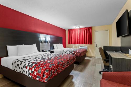 a hotel room with two beds and a desk at Econo Lodge Inn & Suites Santa Rosa in Santa Rosa