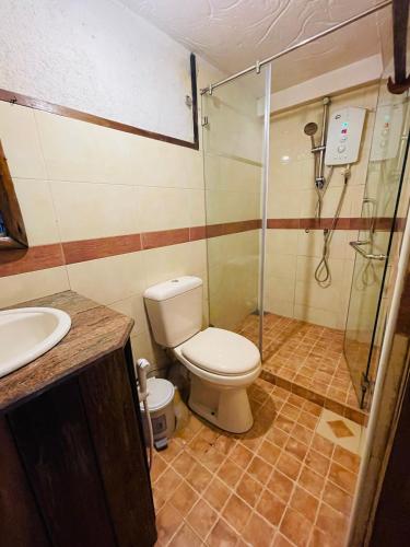 a bathroom with a toilet and a shower at The Lake Frost in Nuwara Eliya