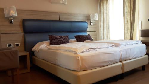 Postel nebo postele na pokoji v ubytování Hotel Galvani