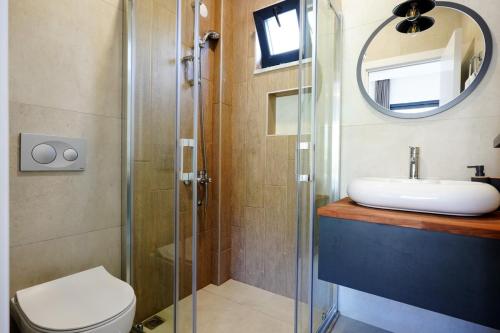 a bathroom with a sink and a toilet and a mirror at Villa Nature Lux in Ortaca