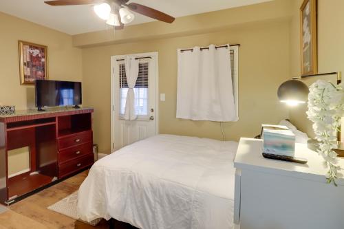 a bedroom with a bed and a flat screen tv at 1 Mi to Dtwn Wilmington Convenient and Cozy Home! in Wilmington