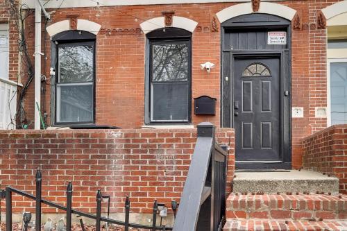 a brick house with a black door and two windows at 1 Mi to Dtwn Wilmington Convenient and Cozy Home! in Wilmington