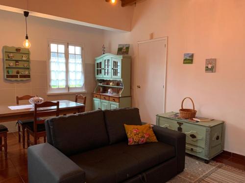 a living room with a couch and a table at Residência Mariana in Furnas