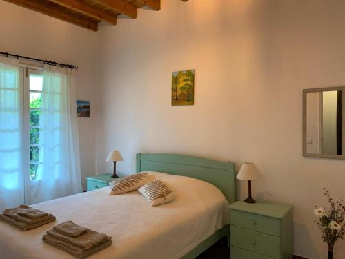 a bedroom with a bed with two towels on it at Residência Mariana in Furnas