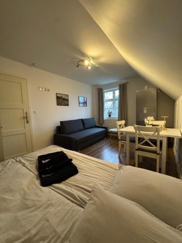 a bedroom with a bed and a couch and a table at Casa de Rainer Copenhagen Room 7 in Copenhagen