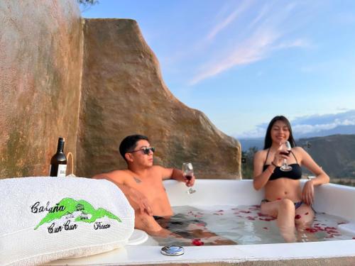 a man and woman sitting in a bath tub with wine at Destinos Exclusivos Patate in Patate