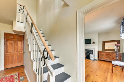a staircase leading to a living room with a wooden door at Georgetown Home Near Kentucky Horse Park! in Georgetown