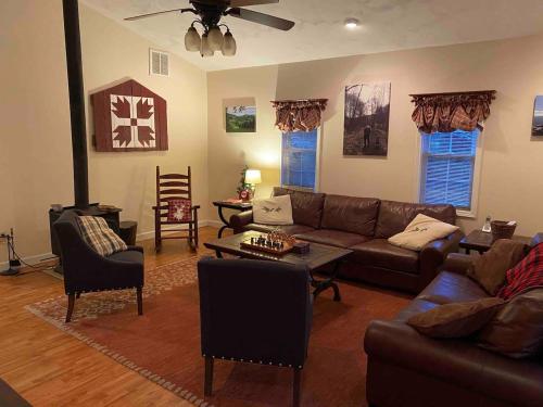 a living room with a couch and a table at Cottage on Creeper Trail with Wide Open Acreage in Damascus
