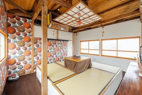 a room with a table and a wall of bowls at Guesthouse & Kitchen Hace - Vacation STAY 75344v in Iwaki
