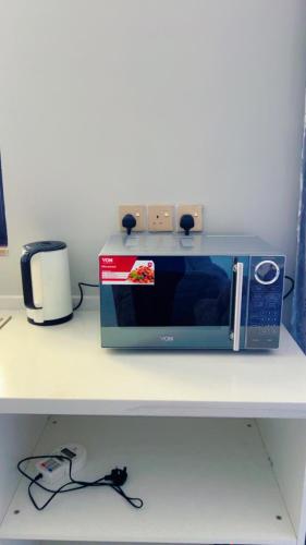 a microwave sitting on top of a counter at Caster two bedrooms apartment jkia in Nairobi