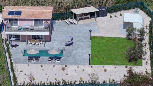 an aerial view of a house with a backyard at Valley House in Vasiliki