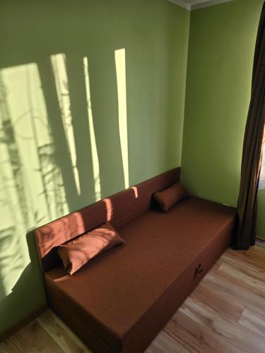 a couch sitting in a room with a window at Kwatera27 in Kleszczele
