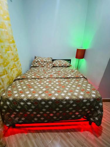 a bedroom with a bed with a red light on it at gustavo in Sokon
