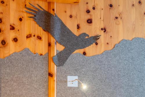 a picture of a bird on a wall with a light at Ferienwohnung Ferienglück in Krün
