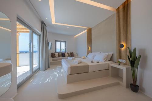 a white bedroom with a bed and a couch at Kastraki Riviera in Kastraki Naxou