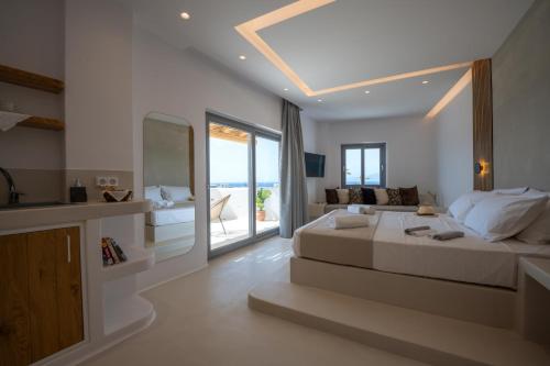 a bedroom with a large bed and a living room at Kastraki Riviera in Kastraki Naxou