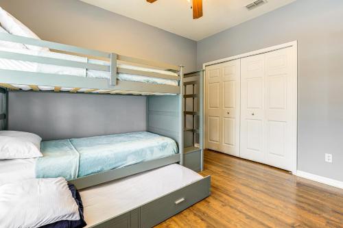 a bedroom with two bunk beds and a closet at Pool and Spa Spacious Port St Lucie Villa! in Carlton