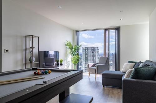 a living room with a pool table and a couch at Manchester City Centre,Picadilly , Skyline View in Manchester