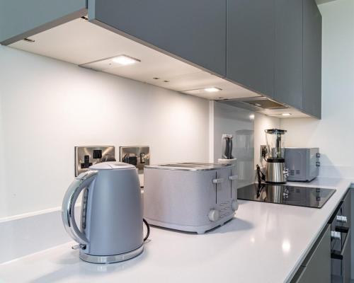 a kitchen with two appliances on a counter at Manchester City Centre,Picadilly , Skyline View in Manchester