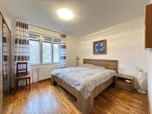 a bedroom with a bed and a chair in it at House Amalia in Bled