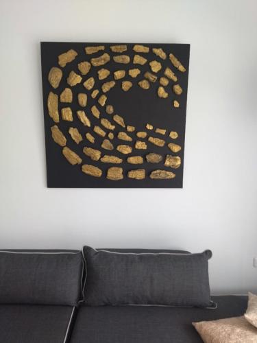 a painting on a wall above a couch at Kampus Living Luxury Complex in Faliraki