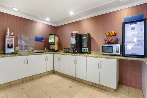 a kitchen with white cabinets and a counter with microwaves at Best Western Inn Santa Cruz in Santa Cruz