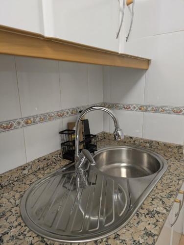 a stainless steel sink in a kitchen counter at O Pisiño de Andrés in Caldas de Reis