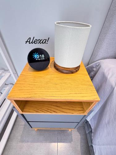 a nightstand with a lamp on top of a bed at La Estancia Residencial in Iguape