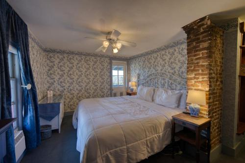 a bedroom with a bed and a brick wall at Downtown Parking Room With a View Piedmont in Eureka Springs