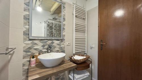 a bathroom with a white sink and a mirror at Ankon Apartments Suite Don Gioia in Ancona