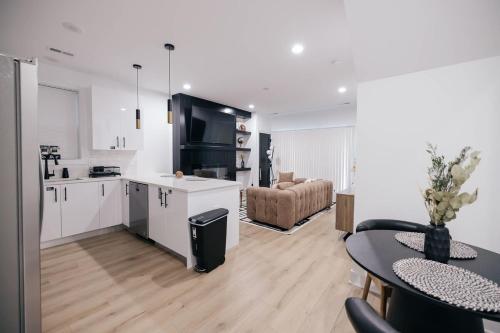 a kitchen and living room with a table and a couch at Parisian Retreat 6min to Main Quandrangle U of C in Chicago