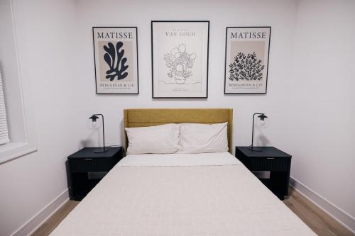 a bedroom with a bed with three pictures on the wall at Parisian Retreat 6min to Main Quandrangle U of C in Chicago