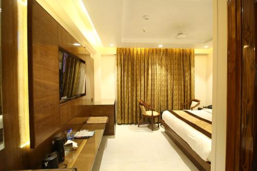a hotel room with a bed and a window at Hotel Grand Plaza in City Centre - Walking Distance From New Delhi Railway Station and Connaught Place in New Delhi