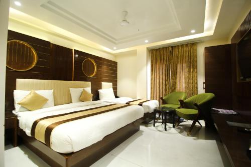 a bedroom with a bed and a table and chairs at Hotel Grand Plaza in City Centre - Walking Distance From New Delhi Railway Station and Connaught Place in New Delhi