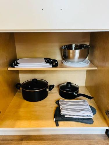 a kitchen with two pots and pans on a shelf at Lovely Studio In Downtown Stuart - Renovated #6 in Stuart